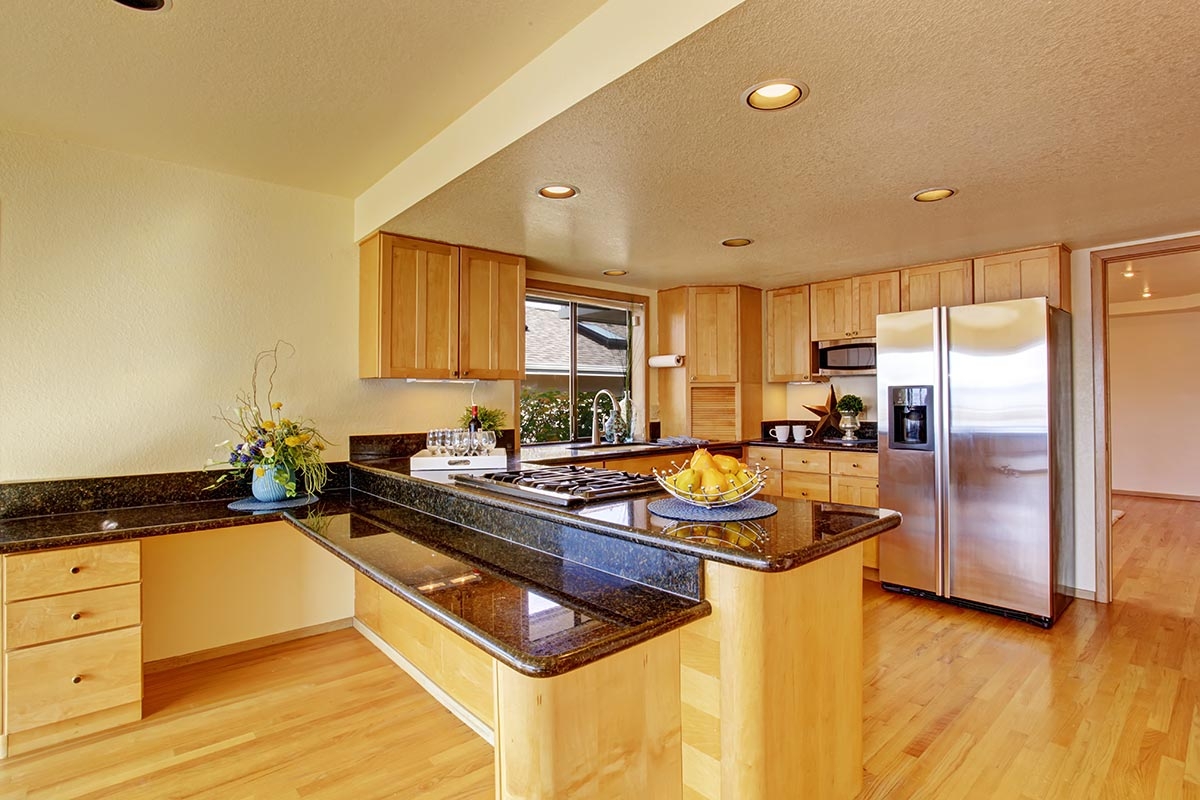Kitchen with black granite countertops