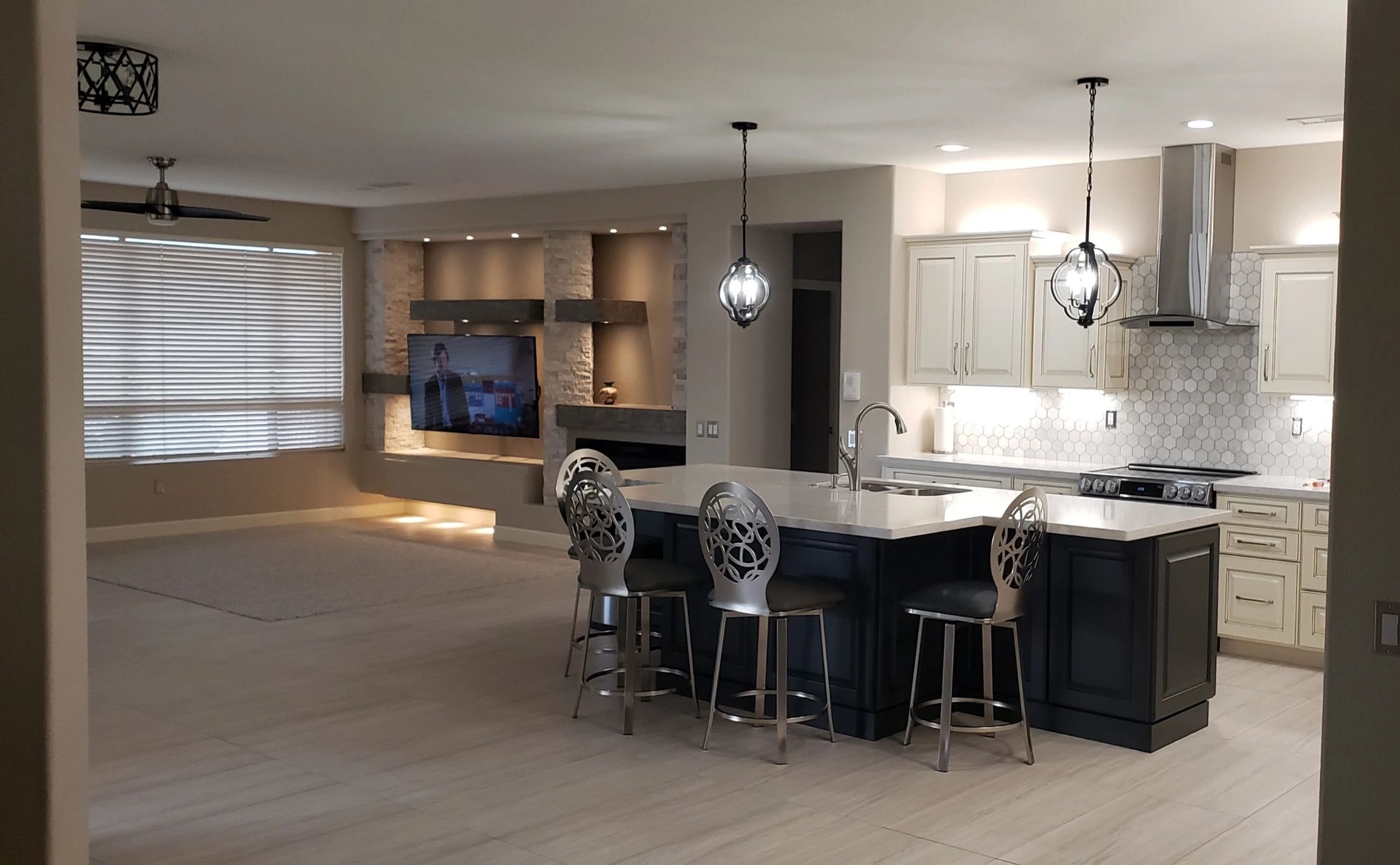 Remodeled white kitchen with granite countertops and a large island
