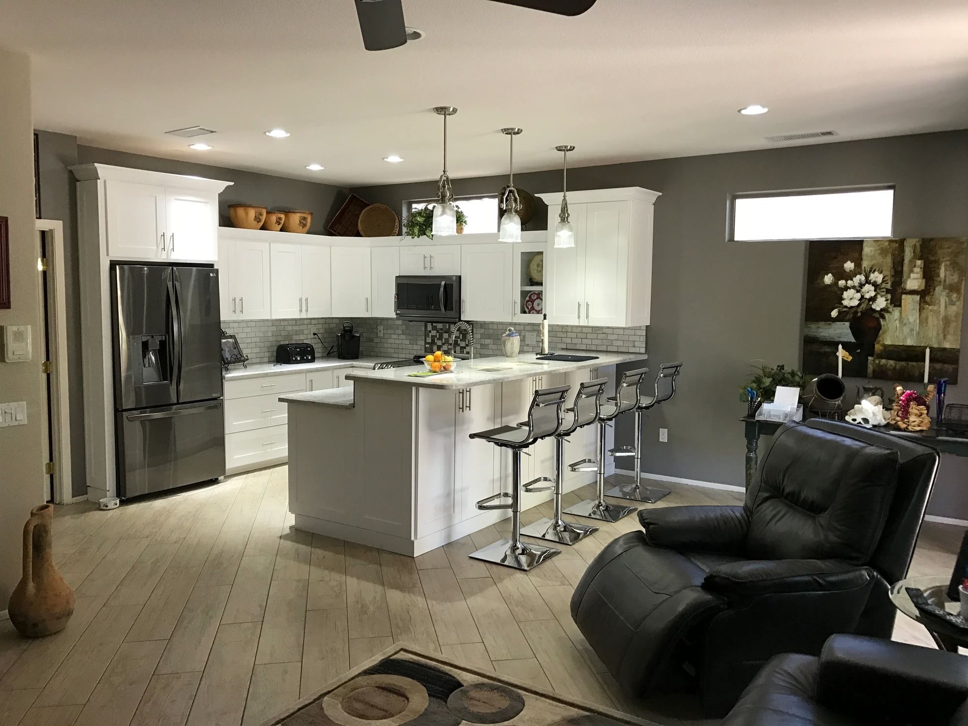 Full white kitchen remodel with island and stone countertops